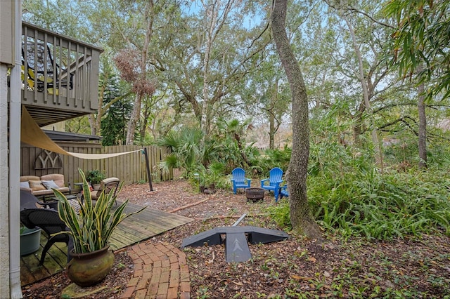 view of patio featuring a wooden deck and an outdoor fire pit