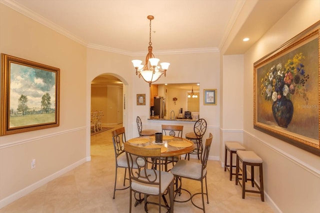 tiled dining area featuring ornamental molding, a chandelier, and sink