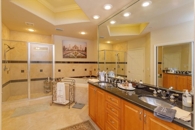 bathroom featuring a raised ceiling, crown molding, vanity, and a shower with shower door