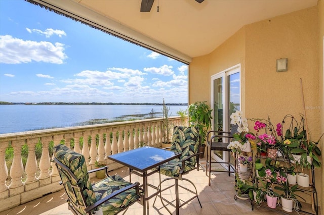 balcony featuring ceiling fan and a water view