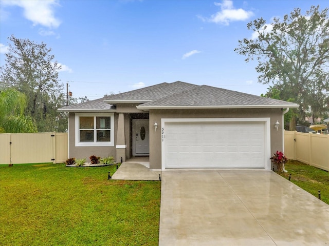 view of front of property featuring a garage and a front lawn