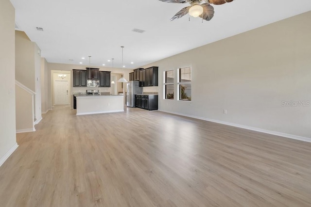 unfurnished living room with ceiling fan and light hardwood / wood-style floors