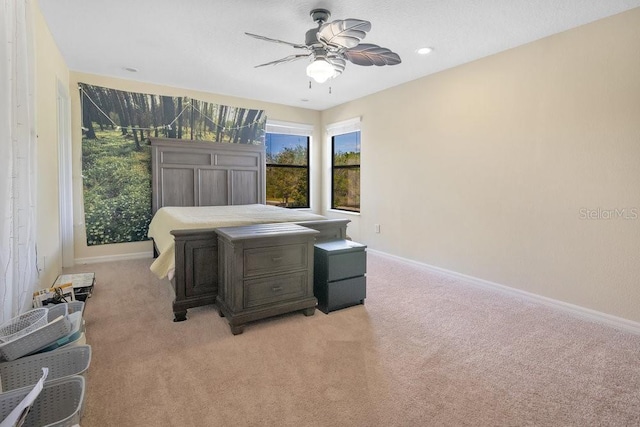 bedroom with light carpet and ceiling fan