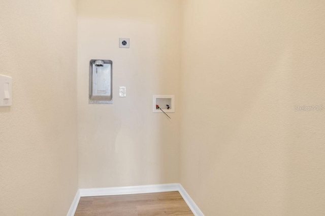 laundry area featuring electric dryer hookup, washer hookup, and light hardwood / wood-style flooring