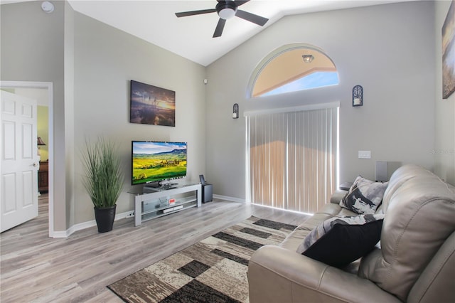 living room with light hardwood / wood-style flooring, vaulted ceiling, and ceiling fan