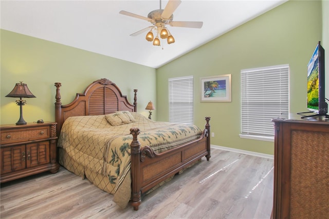 bedroom featuring ceiling fan, lofted ceiling, and light wood-type flooring