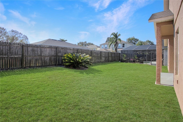 view of yard with glass enclosure