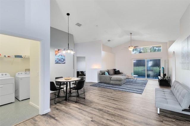 living room with hardwood / wood-style floors, high vaulted ceiling, washer and dryer, and ceiling fan