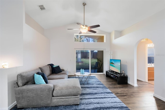 living room featuring dark wood-type flooring, high vaulted ceiling, and ceiling fan