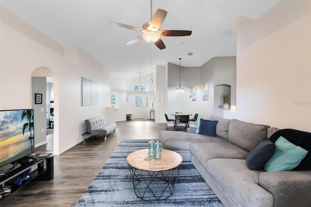 living room featuring vaulted ceiling, dark hardwood / wood-style floors, and ceiling fan