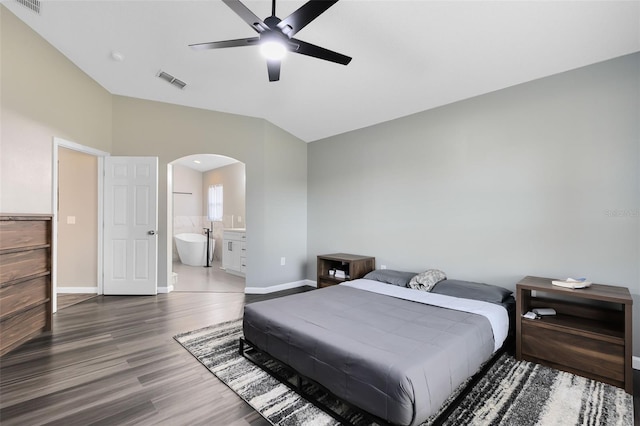 bedroom featuring hardwood / wood-style flooring, ensuite bathroom, vaulted ceiling, and ceiling fan