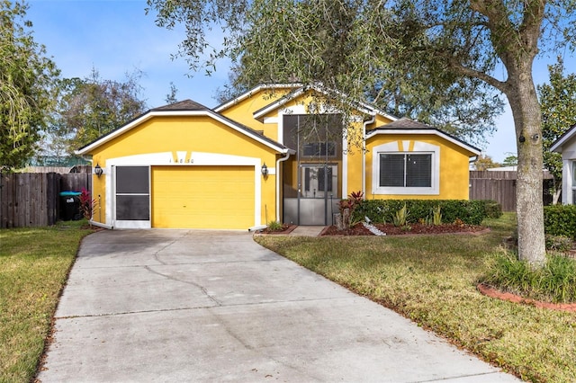 view of front of home featuring a garage and a front lawn