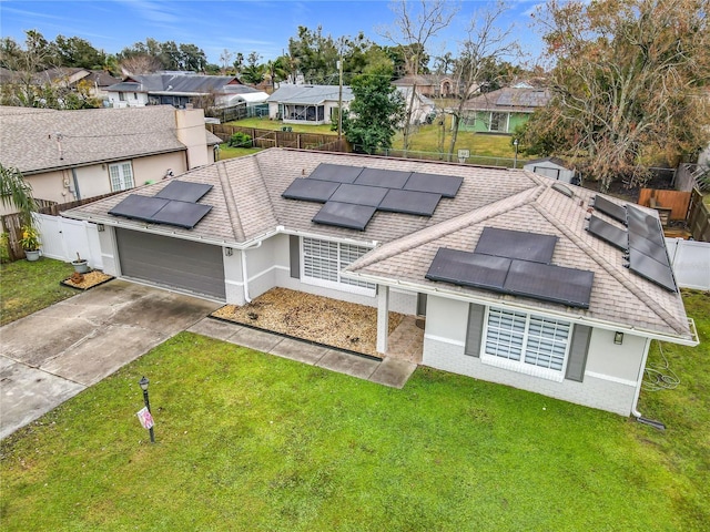 exterior space featuring a garage and a front lawn