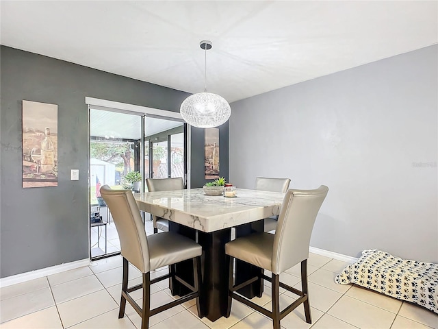 tiled dining area with an inviting chandelier