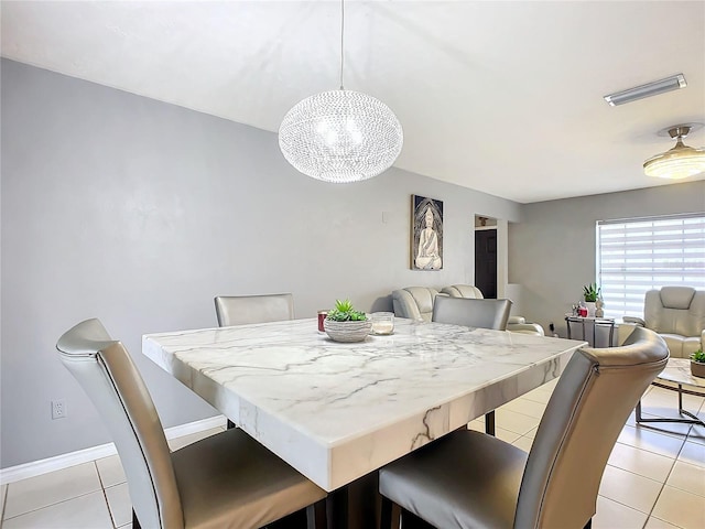 dining space with light tile patterned floors and a notable chandelier