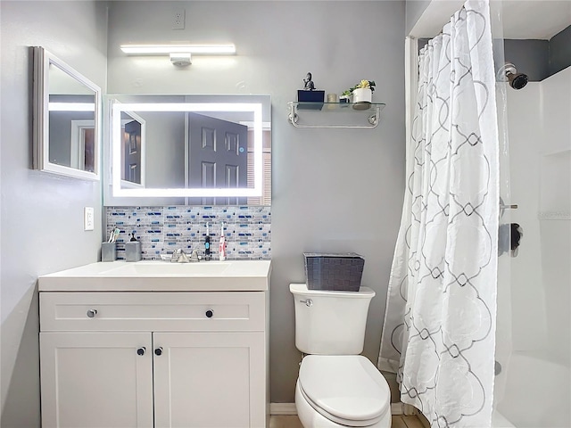 bathroom featuring tasteful backsplash, vanity, a shower with shower curtain, and toilet