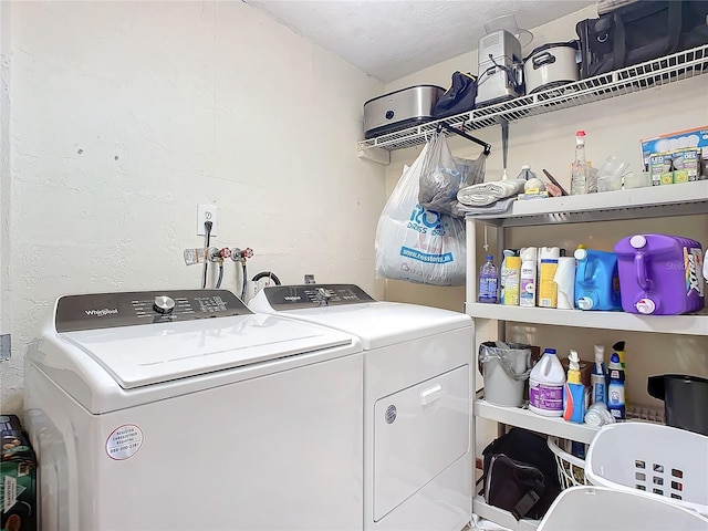 clothes washing area featuring independent washer and dryer and a textured ceiling