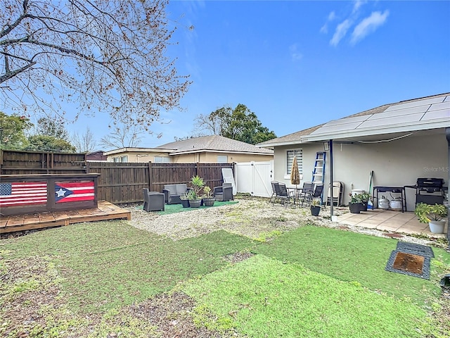 view of yard with a wooden deck, a hot tub, and a patio area