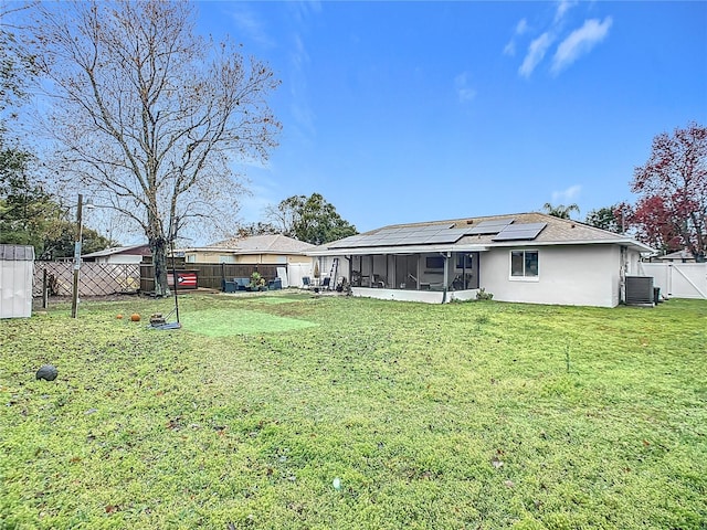 view of yard with central AC unit and a sunroom