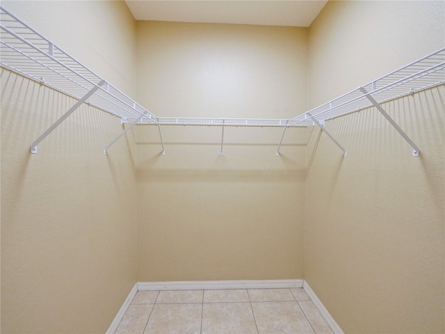 spacious closet featuring light tile patterned floors