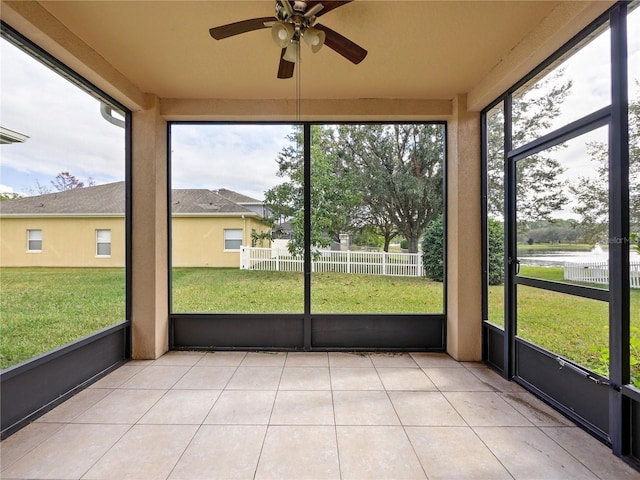 unfurnished sunroom with ceiling fan