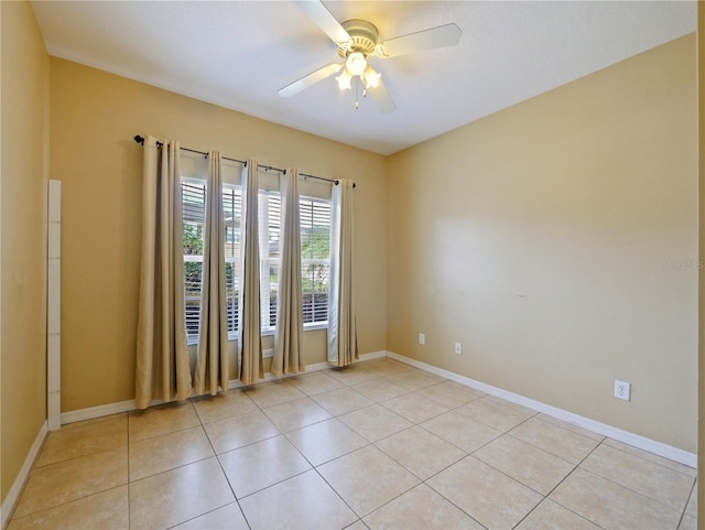 spare room with light tile patterned flooring and ceiling fan