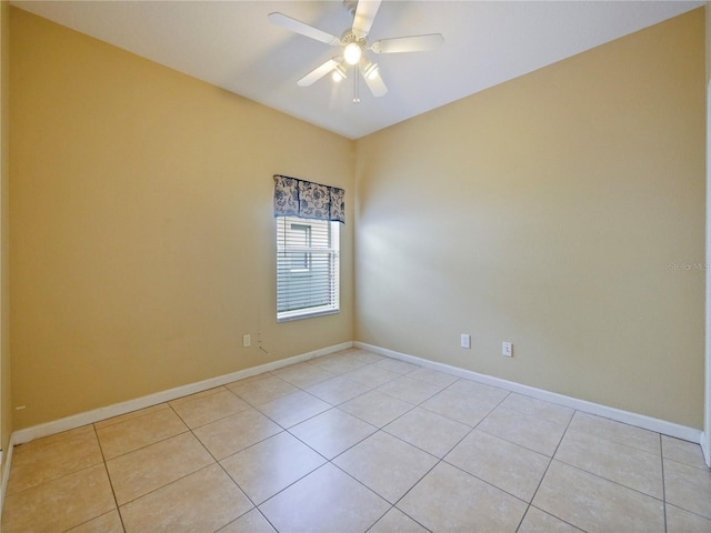 empty room with ceiling fan and light tile patterned flooring