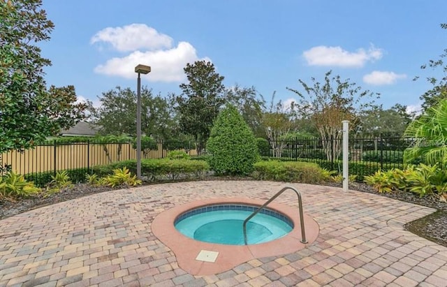 view of swimming pool featuring a community hot tub and a patio