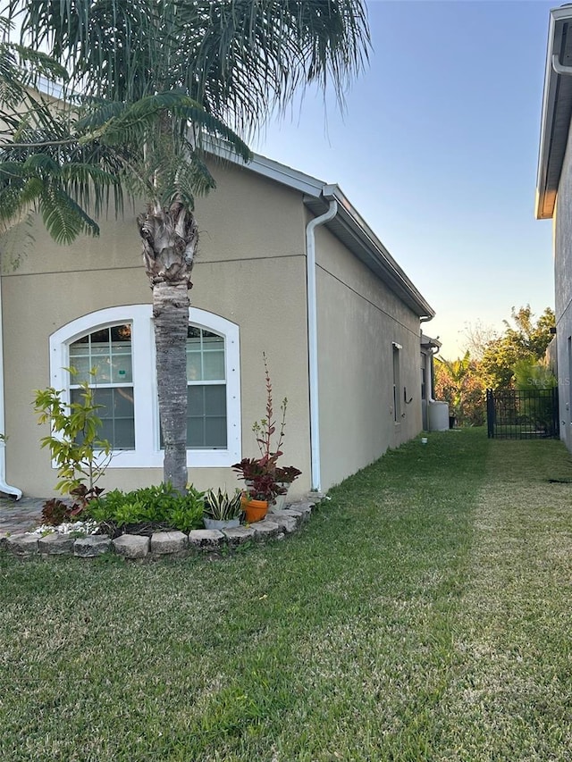 view of side of property with a yard