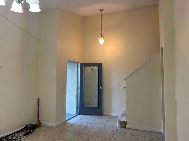 foyer with a high ceiling and light tile patterned floors