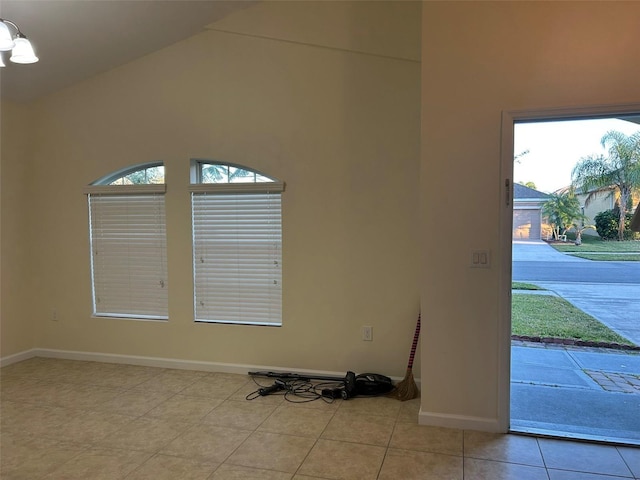 tiled foyer entrance with high vaulted ceiling