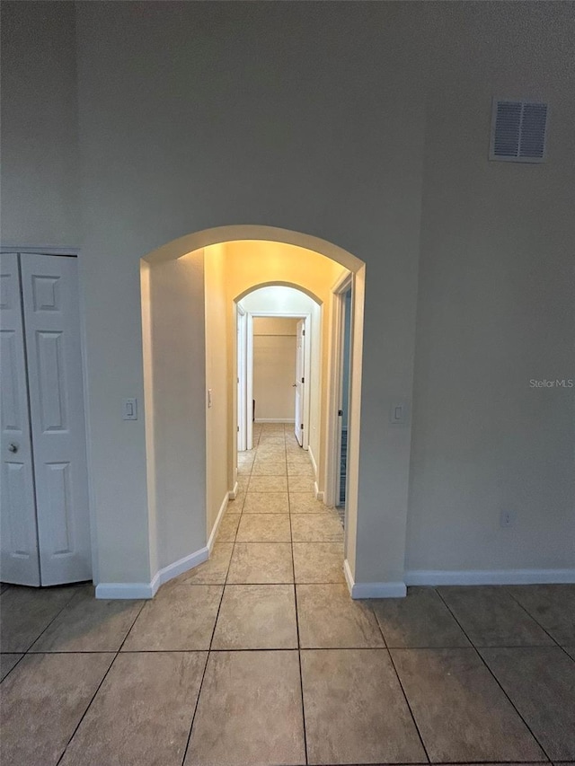 corridor featuring light tile patterned floors