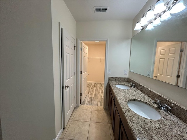 bathroom with vanity, tile patterned floors, and a chandelier