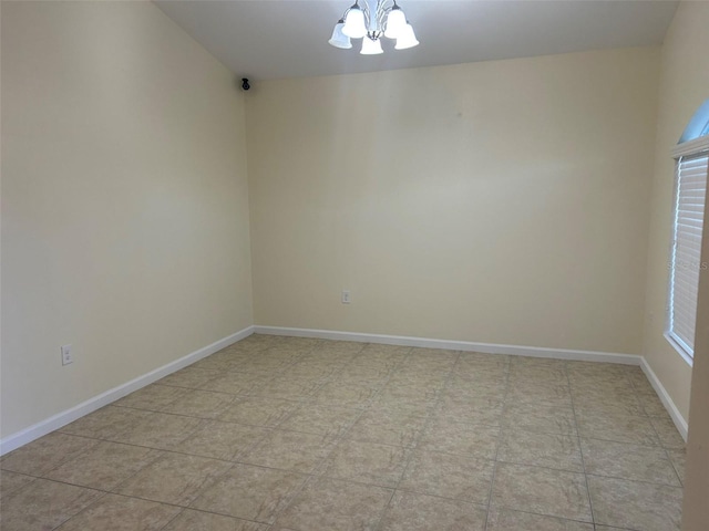 unfurnished room with an inviting chandelier