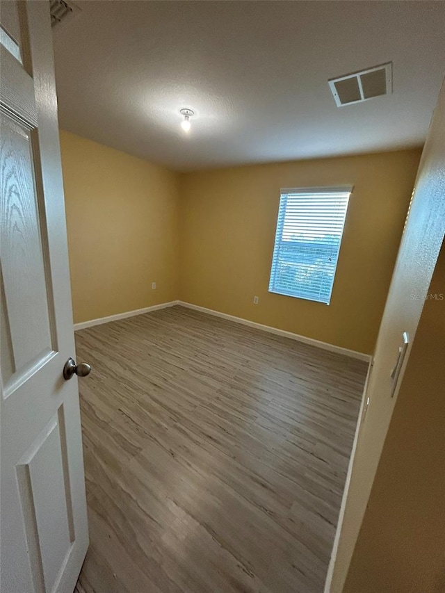 empty room featuring wood-type flooring