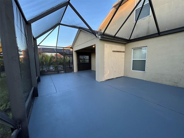 view of patio with glass enclosure