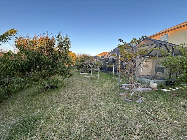 view of yard with glass enclosure