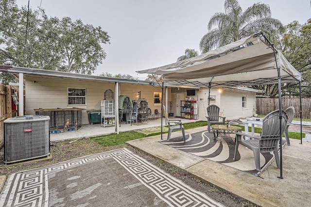 back of property featuring cooling unit, a gazebo, and a patio