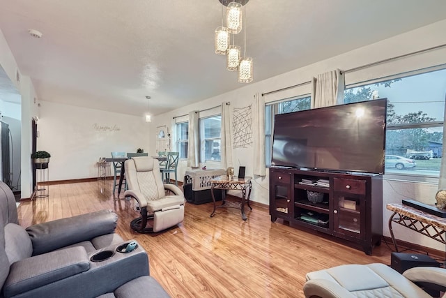 living room featuring a wealth of natural light and light hardwood / wood-style floors