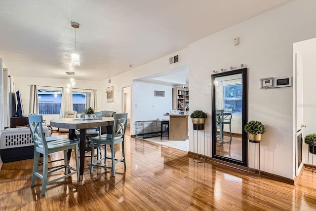 dining area with light hardwood / wood-style floors