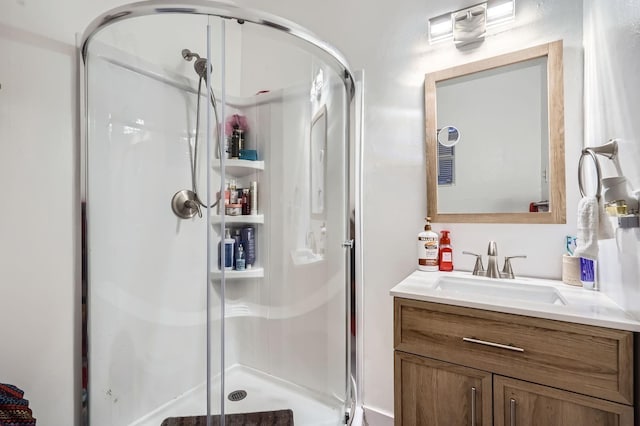 bathroom with vanity and a shower with door