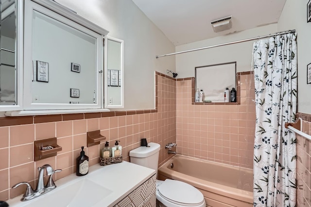 full bathroom with toilet, tasteful backsplash, tile walls, vanity, and shower / bath combo with shower curtain