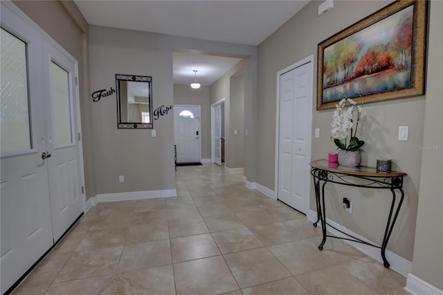 hall featuring light tile patterned floors