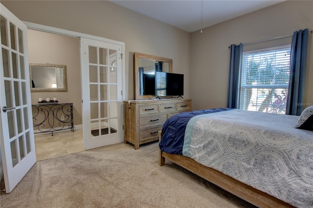 bedroom with light colored carpet and french doors