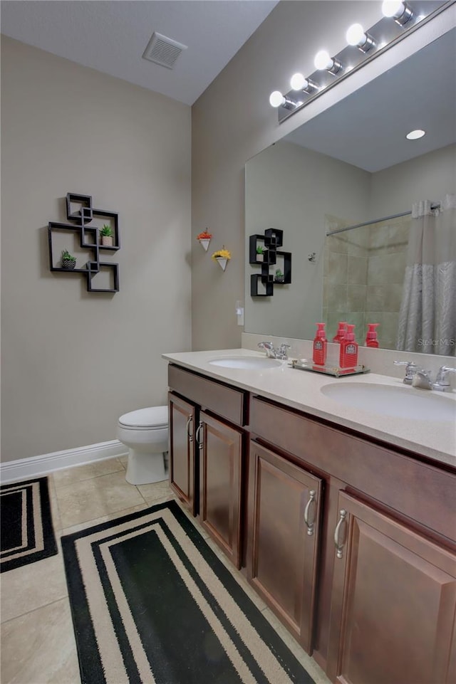 bathroom featuring a shower with curtain, vanity, toilet, and tile patterned flooring