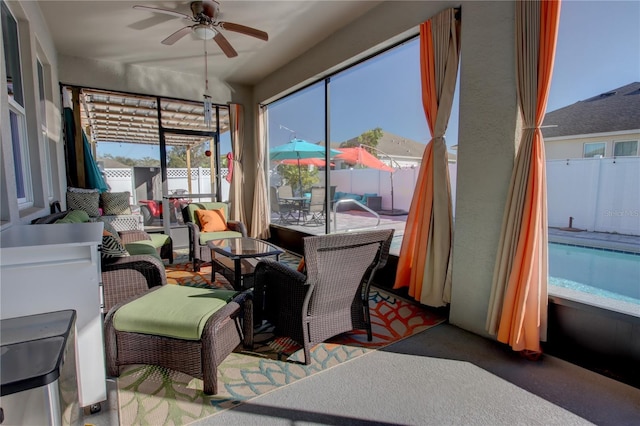 sunroom featuring a healthy amount of sunlight and ceiling fan