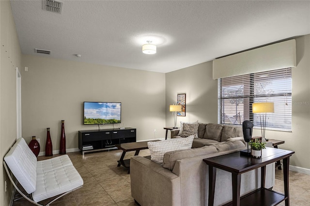 tiled living room with a textured ceiling