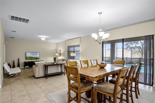 dining space featuring light tile patterned floors and a chandelier