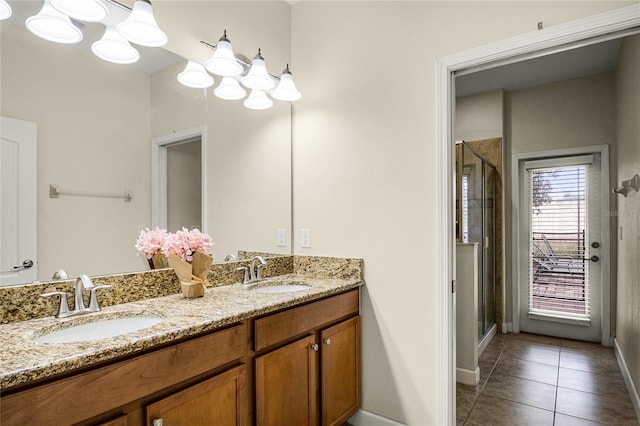 bathroom with tile patterned floors, a shower with shower door, and vanity