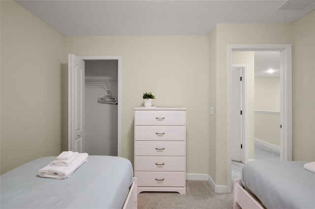 bedroom featuring light colored carpet and a closet